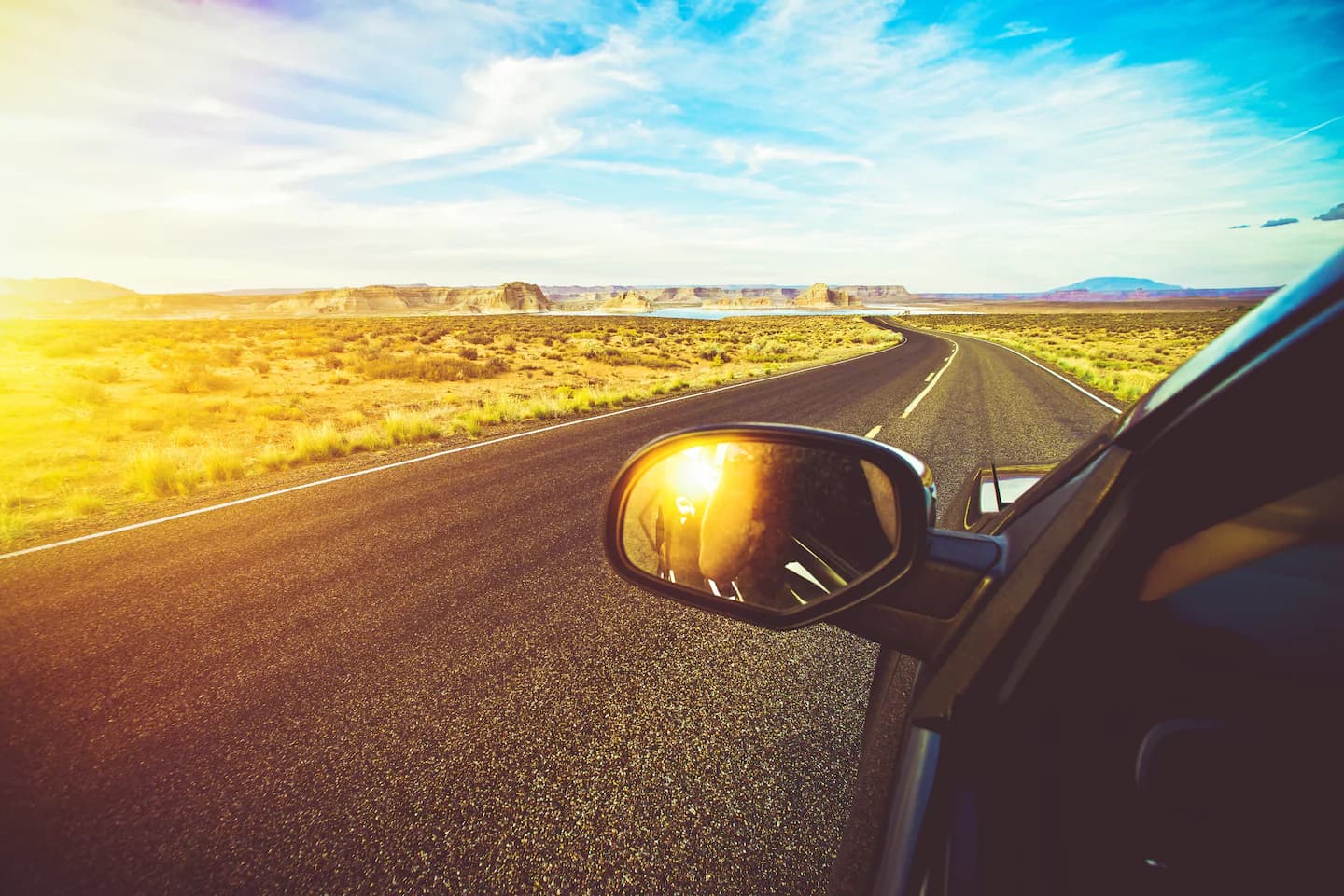 Porsche driving on a desert road